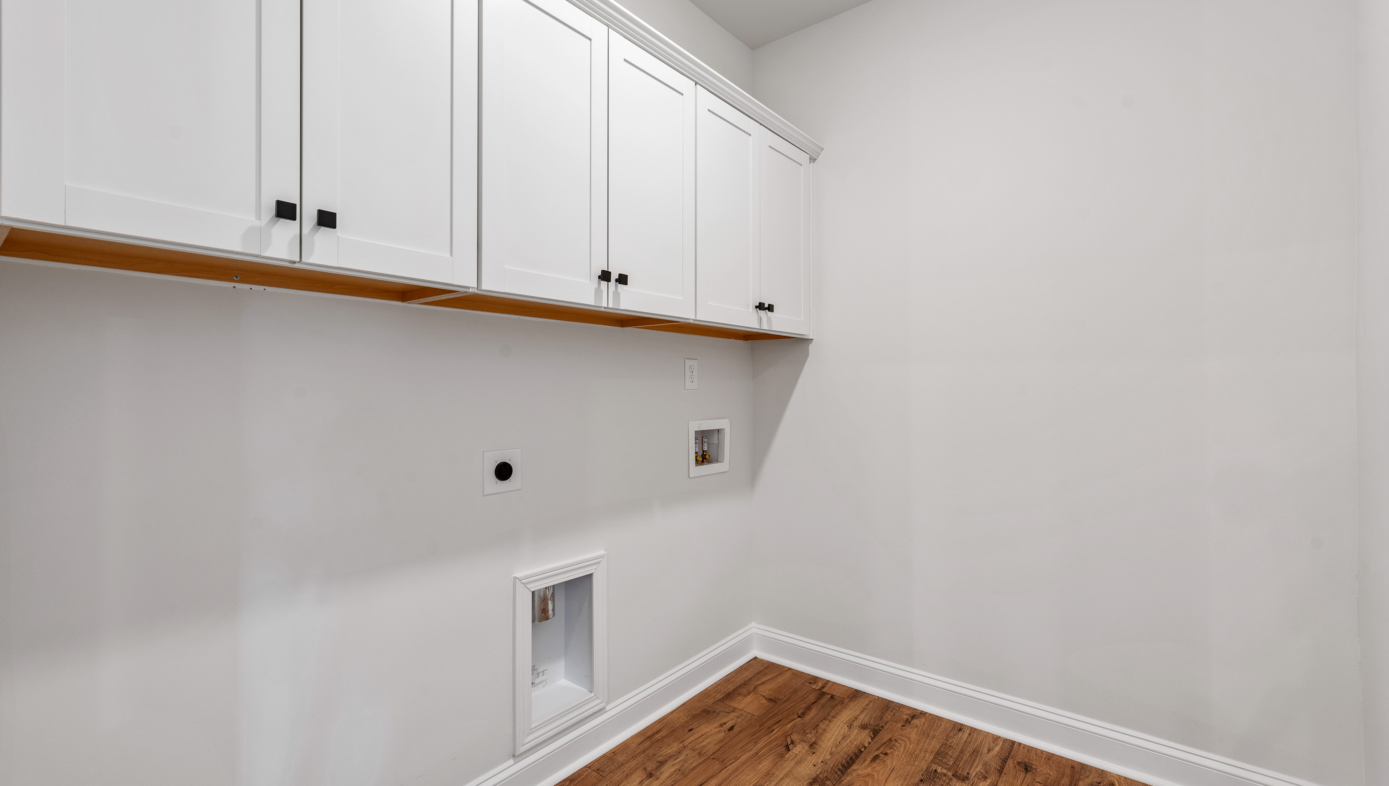 Laundry room with cabinets.