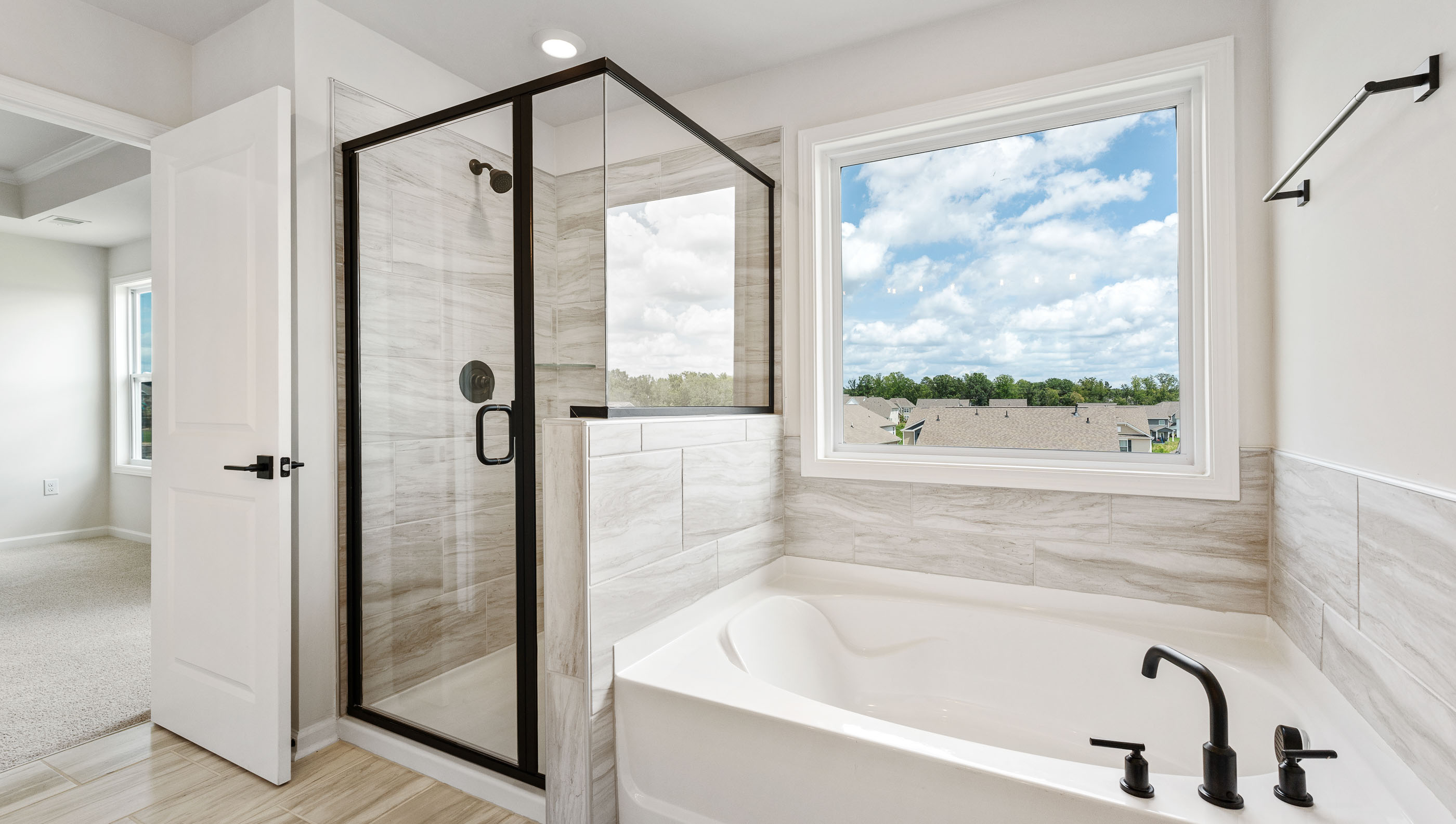 Primary bathroom with walk-in shower and garden tub.