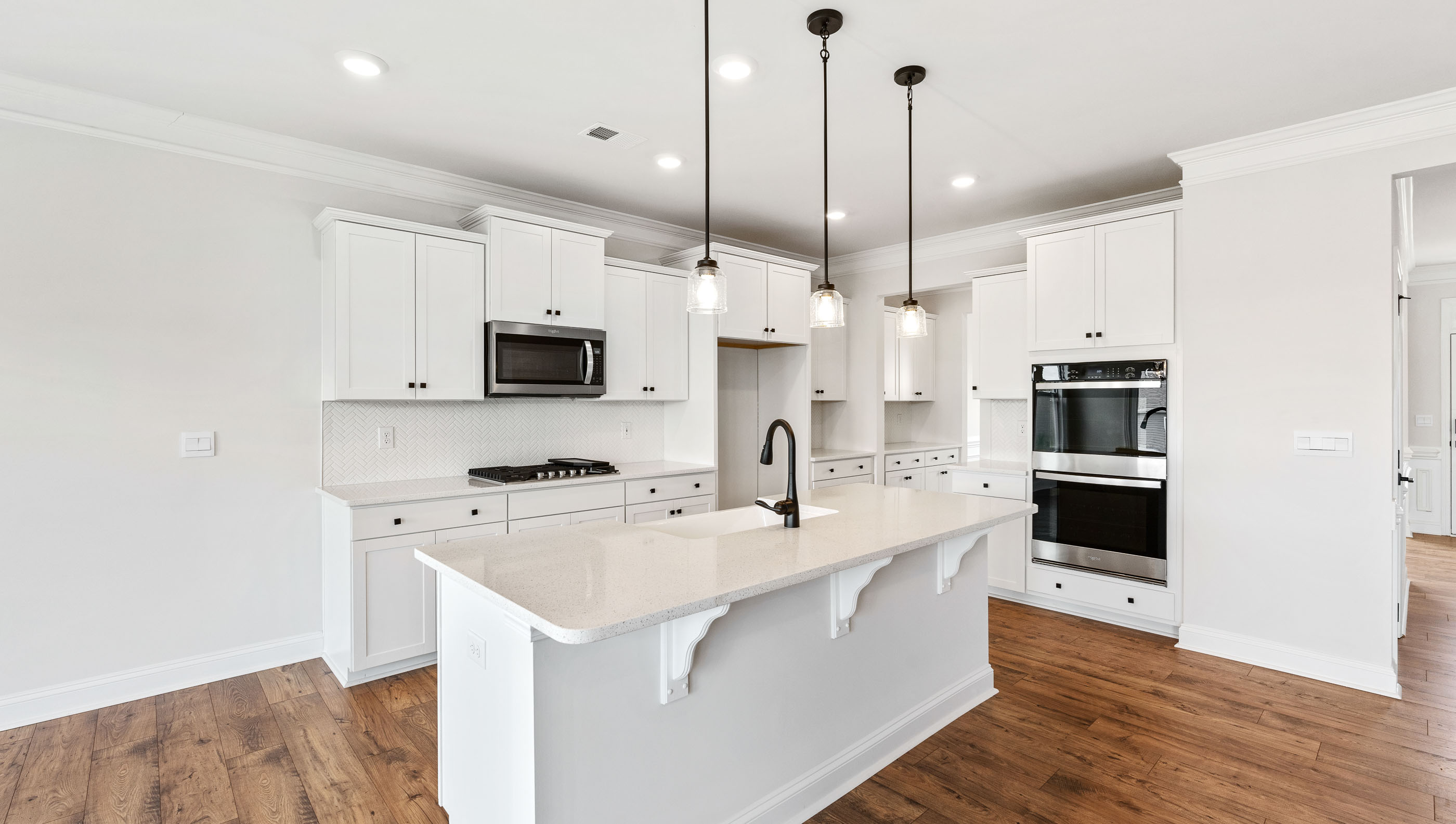 Kitchen with island and granite countertops.