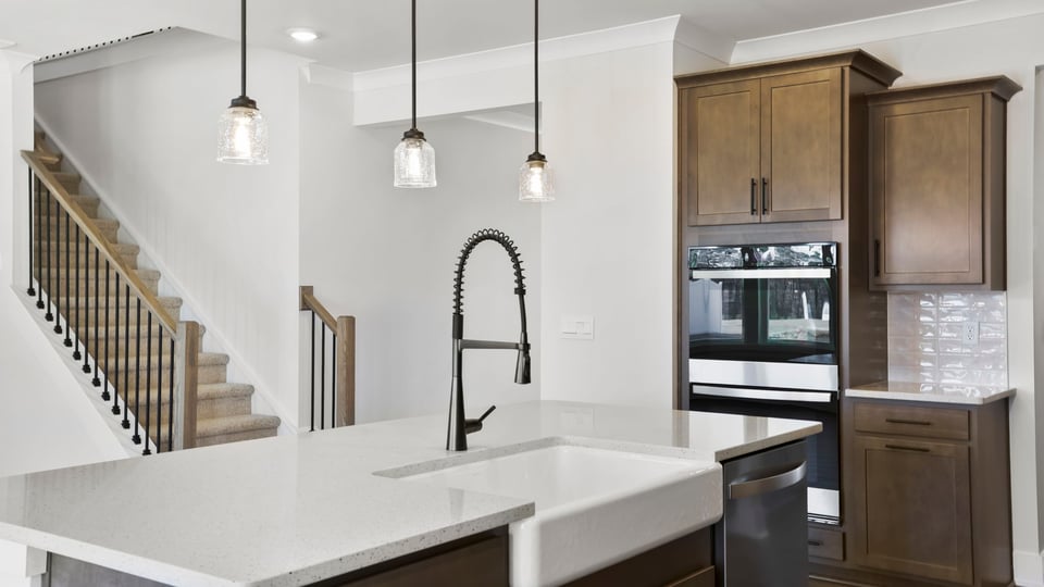 Island and kitchen with quartz countertops.