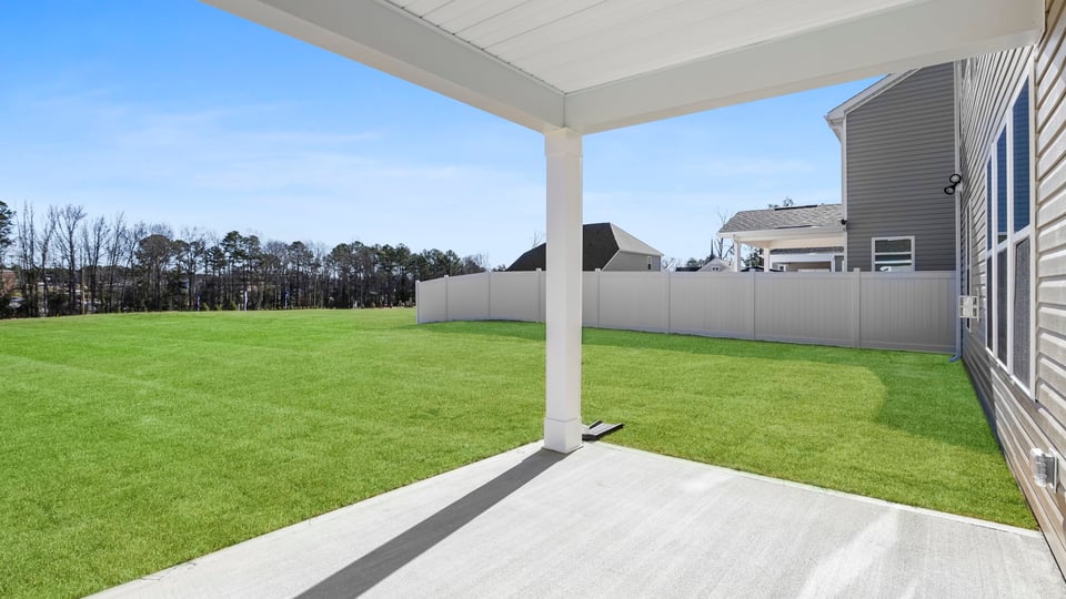 View of back yard from covered patio.