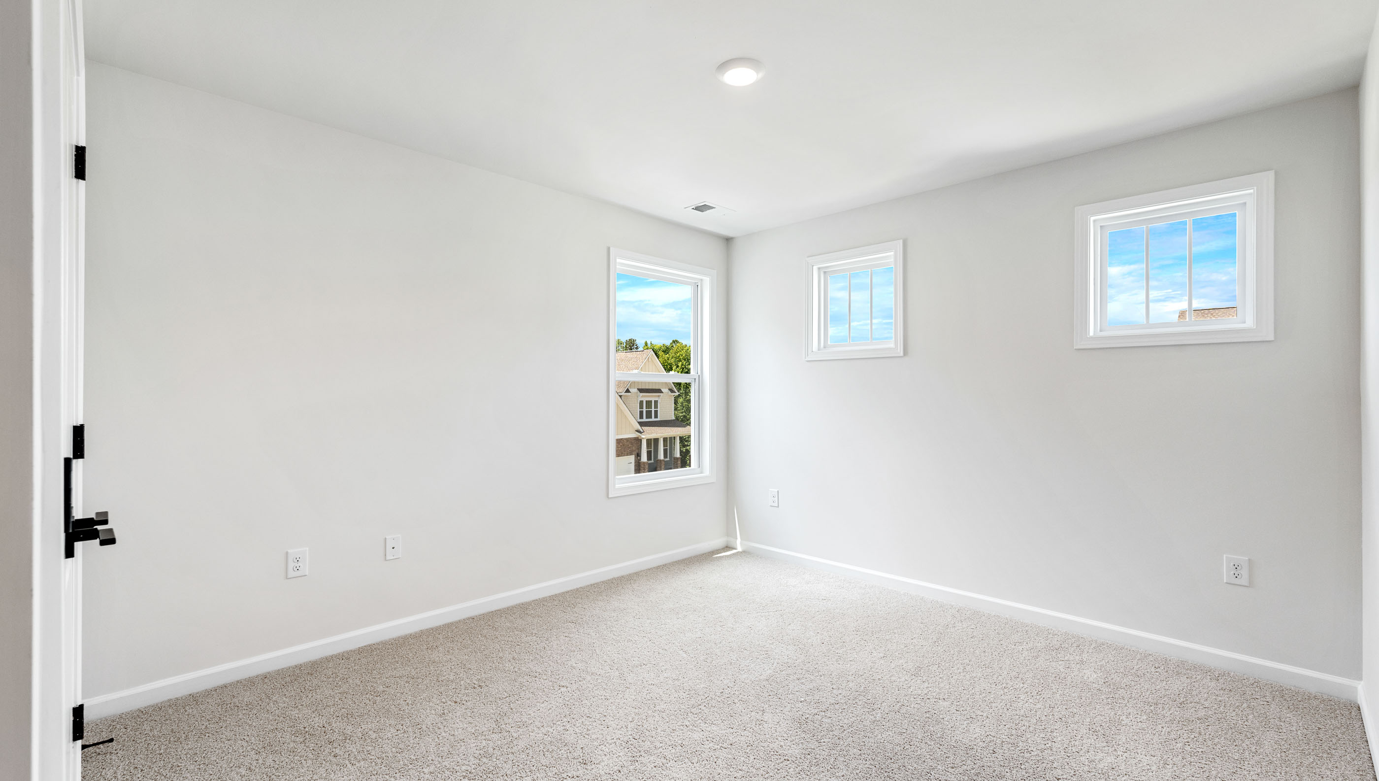 Bedroom with carpet and window.