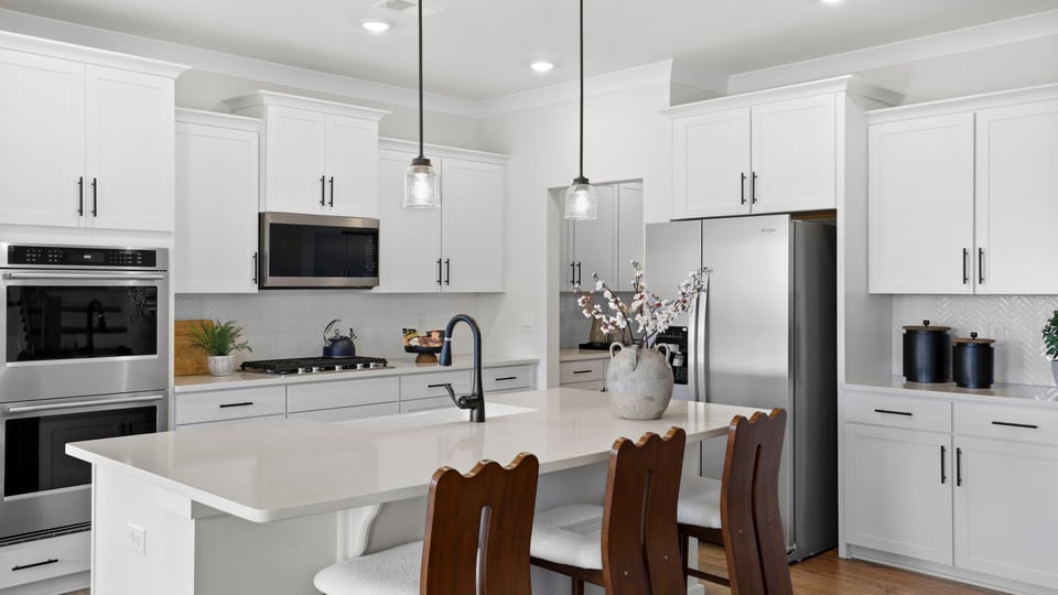 Kitchen and island with quartz countertops and stainless steel appliances.