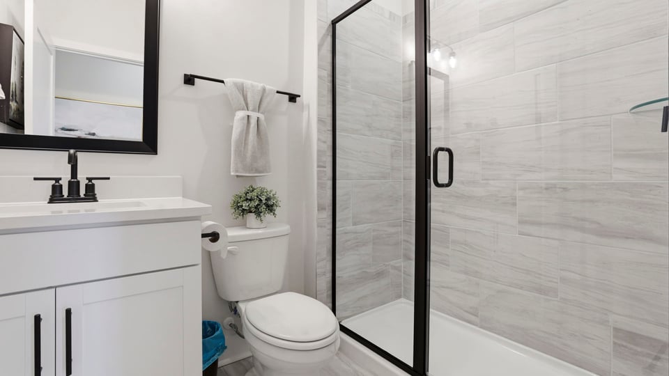 Bathroom with single vanity sink and walk in shower.