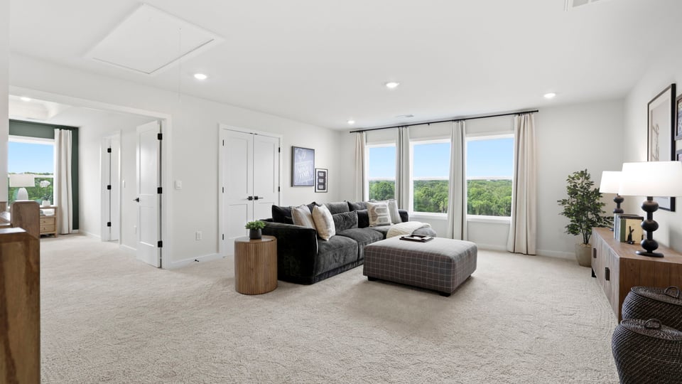 Loft area with carpet and window.
