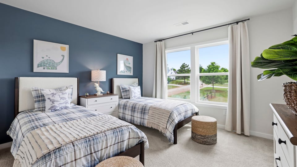 Bedroom with carpet and window.