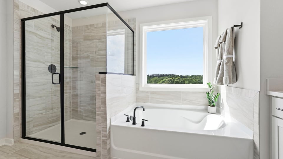 Bathroom with bathtub and walk in shower.