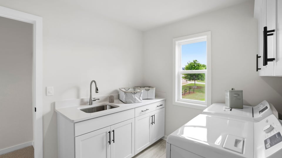 Laundry room with cabinets.