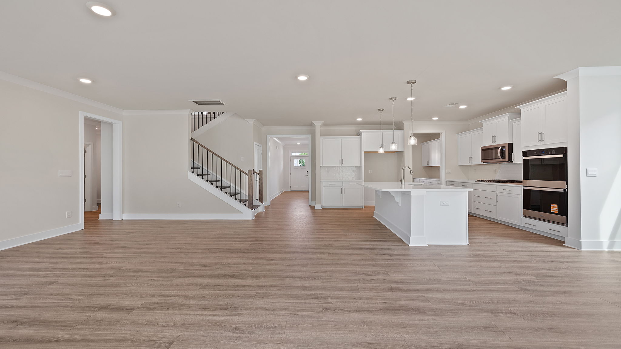 View of the kitchen and stairwell from the family room.