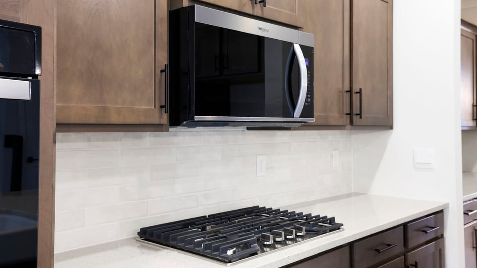 Kitchen and island with quartz countertops.