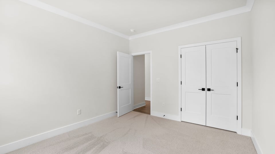 Bedroom with carpet and window.