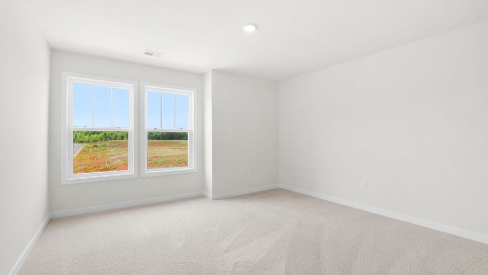 Bedroom with carpet and window.