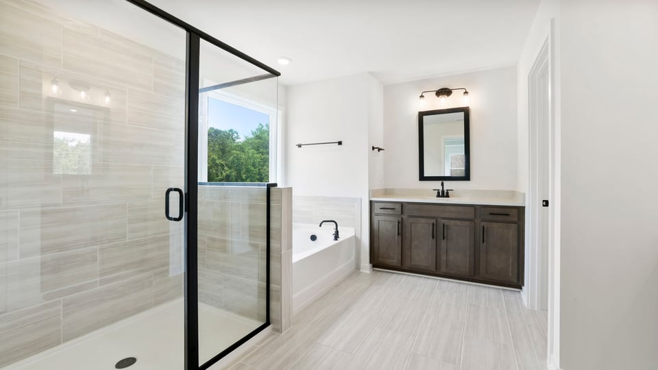 Bathroom with walk in shower and bathtub.
