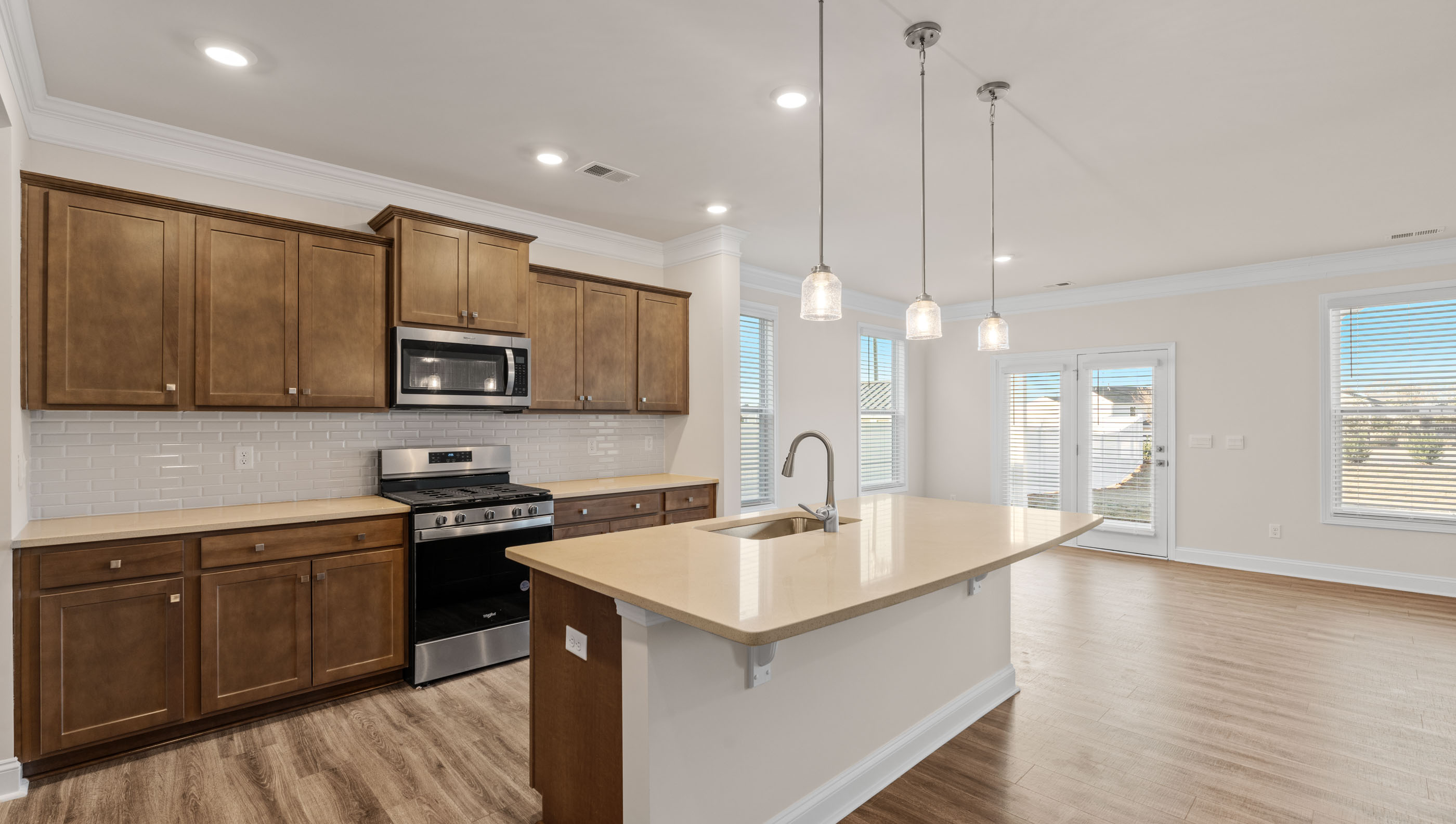 View of kitchen and breakfast area with lots of windows.