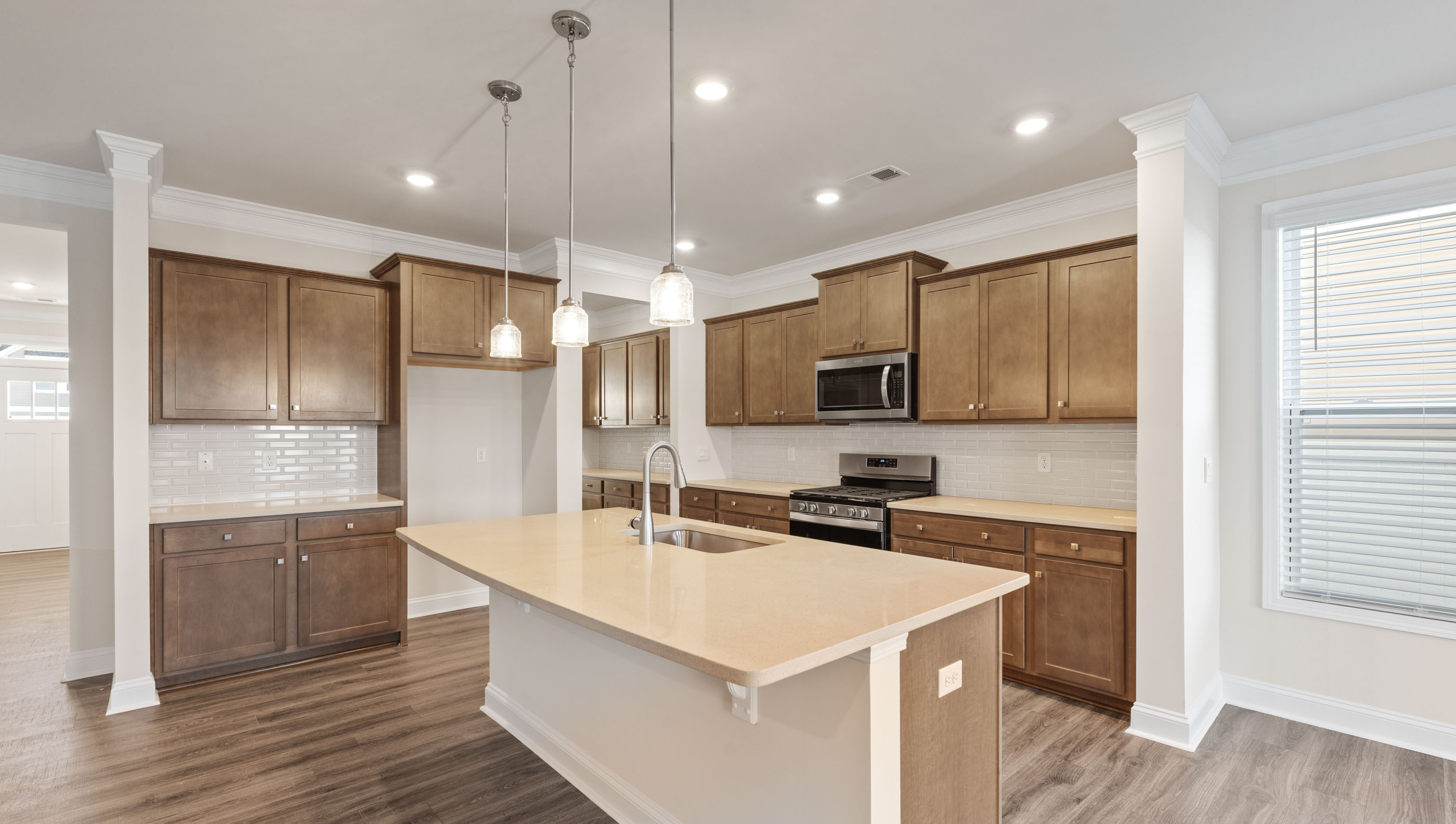 Kitchen with pendulum lighting.
