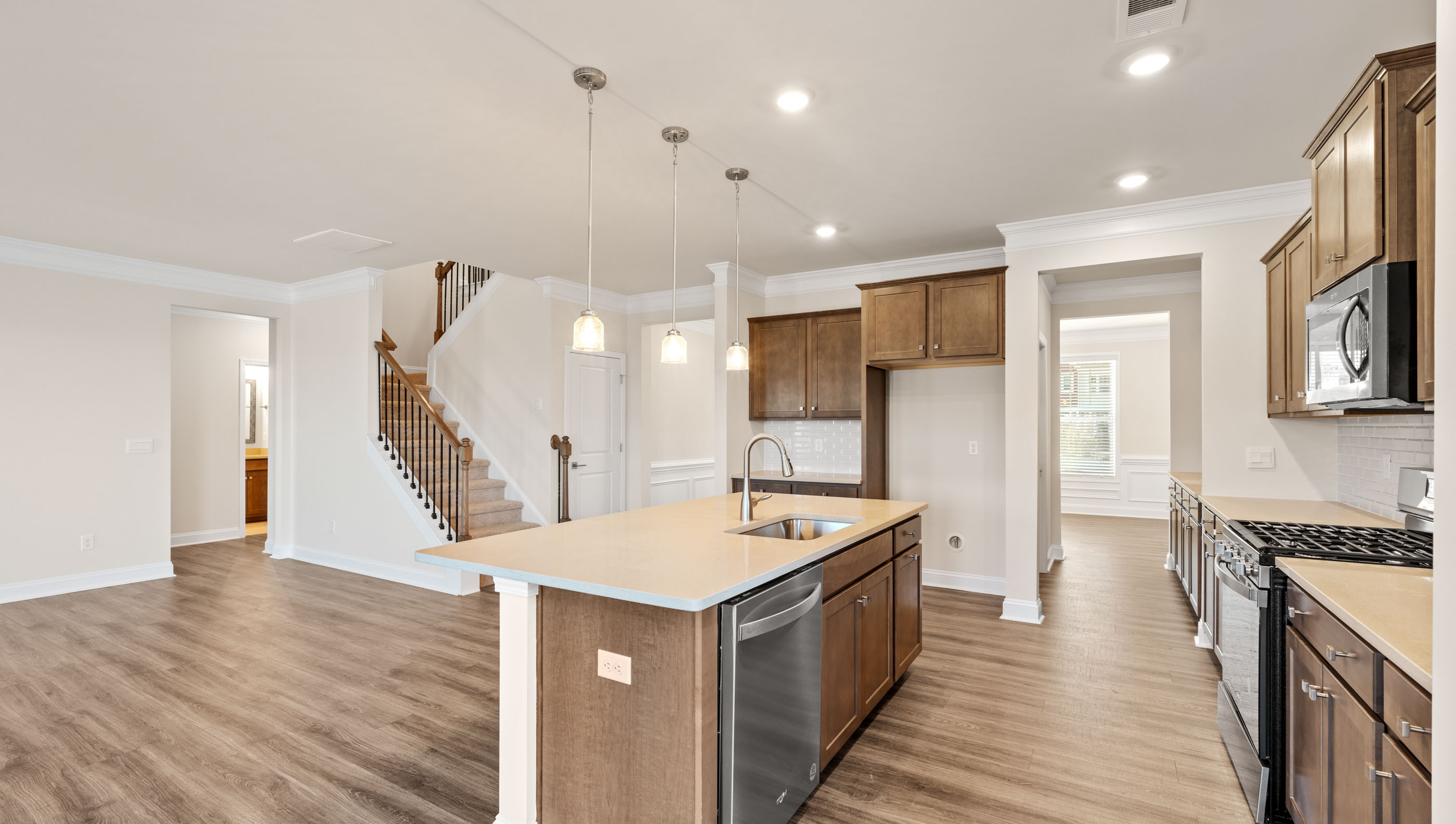 Kitchen with island with quartz countertop.
