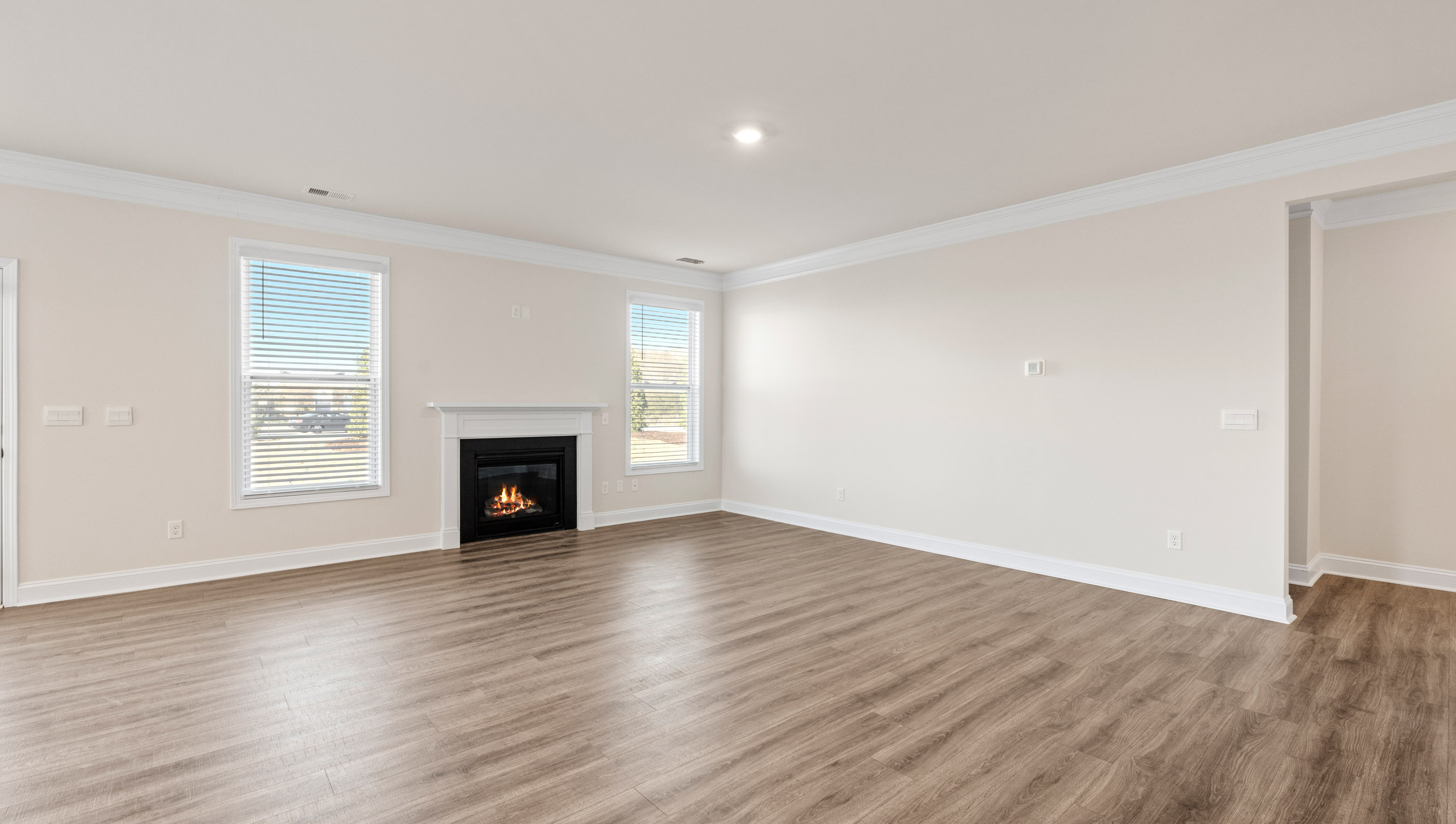 Family room with lots of windows and gas log fireplace.