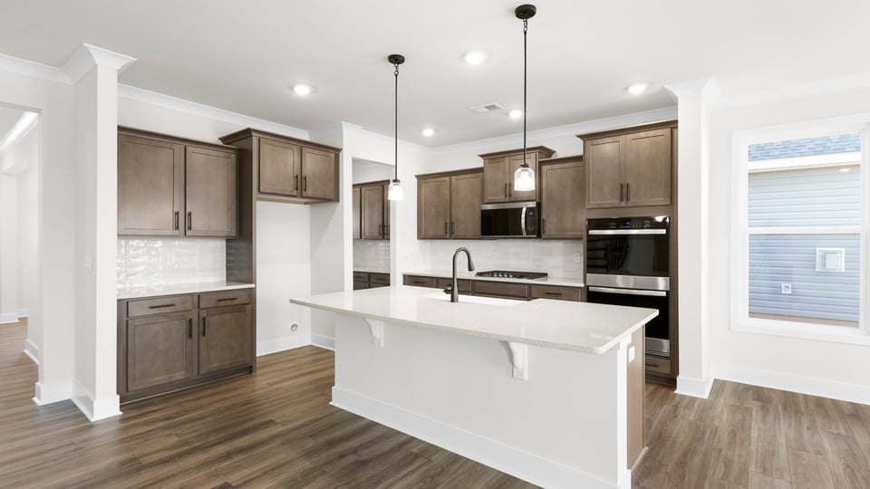 Kitchen with island and pendulum lights.