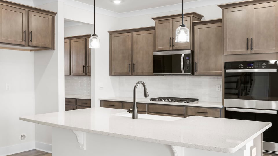 Kitchen with island and quartz countertops.
