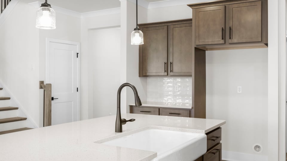 Kitchen with island and quartz countertops.