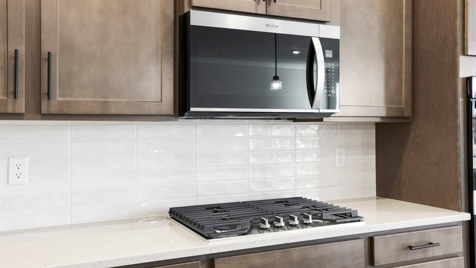 Stainless steel appliances and gas cooktop.