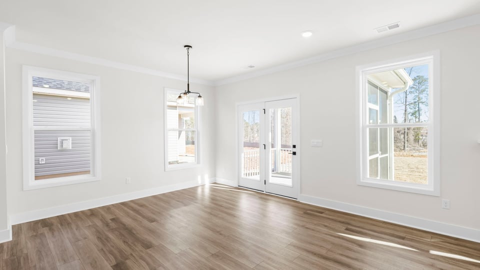 Breakfast area with lots of windows and door to the screened porch.