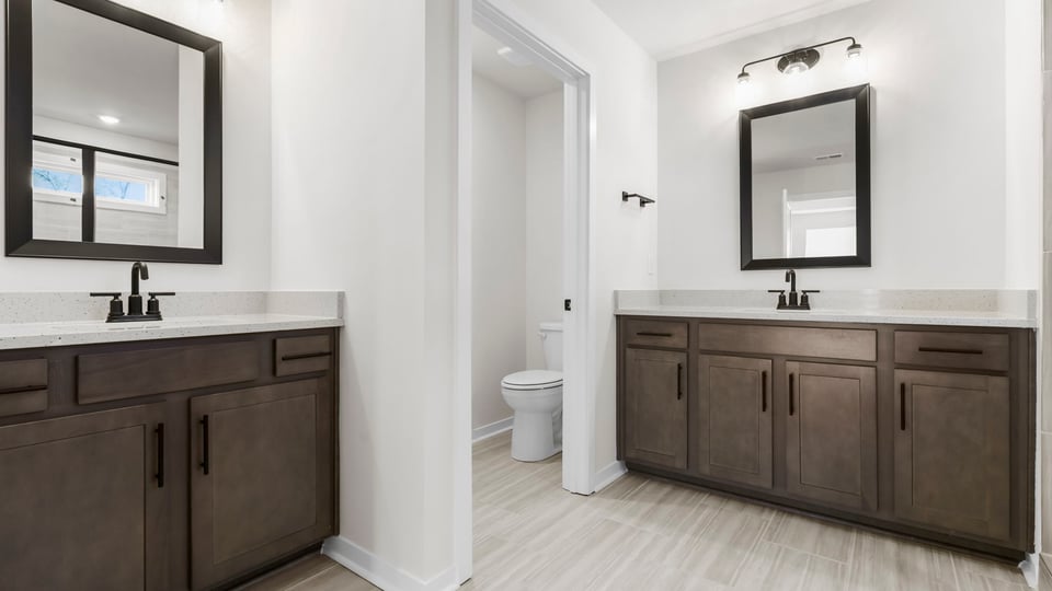 Primary bathroom with his and her vanities.