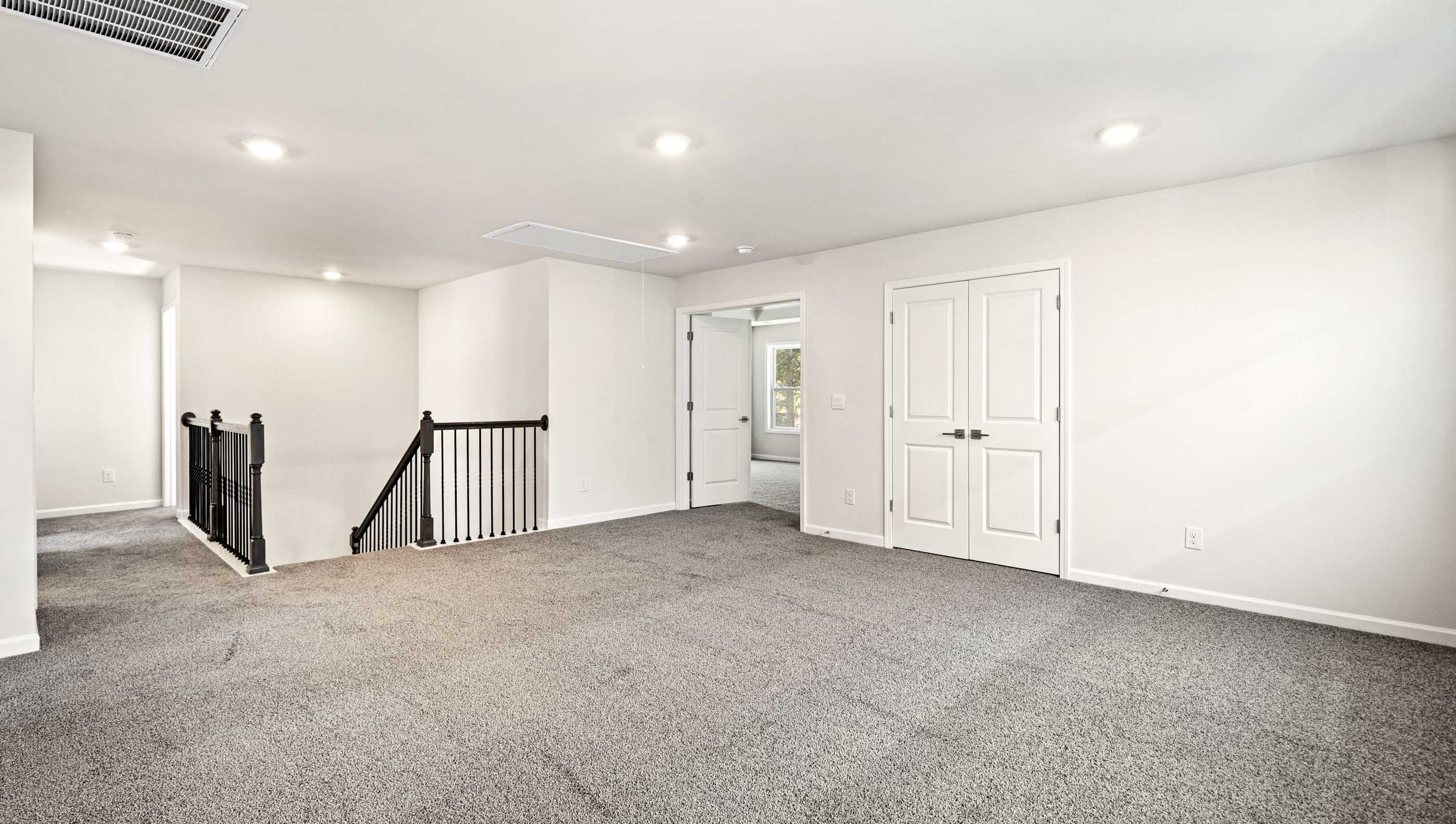 Loft area with carpet.