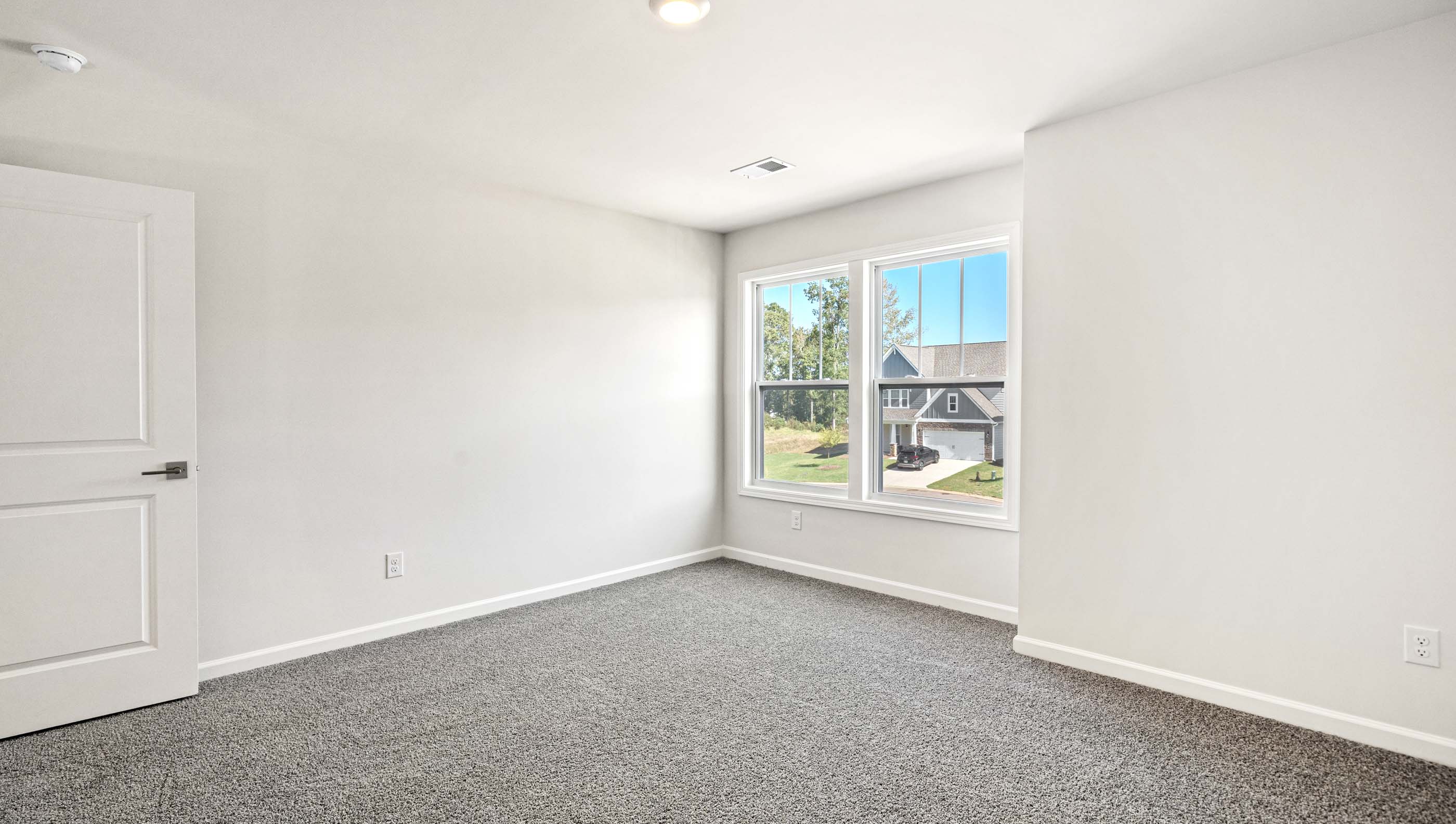 Bedroom with carpet and window.