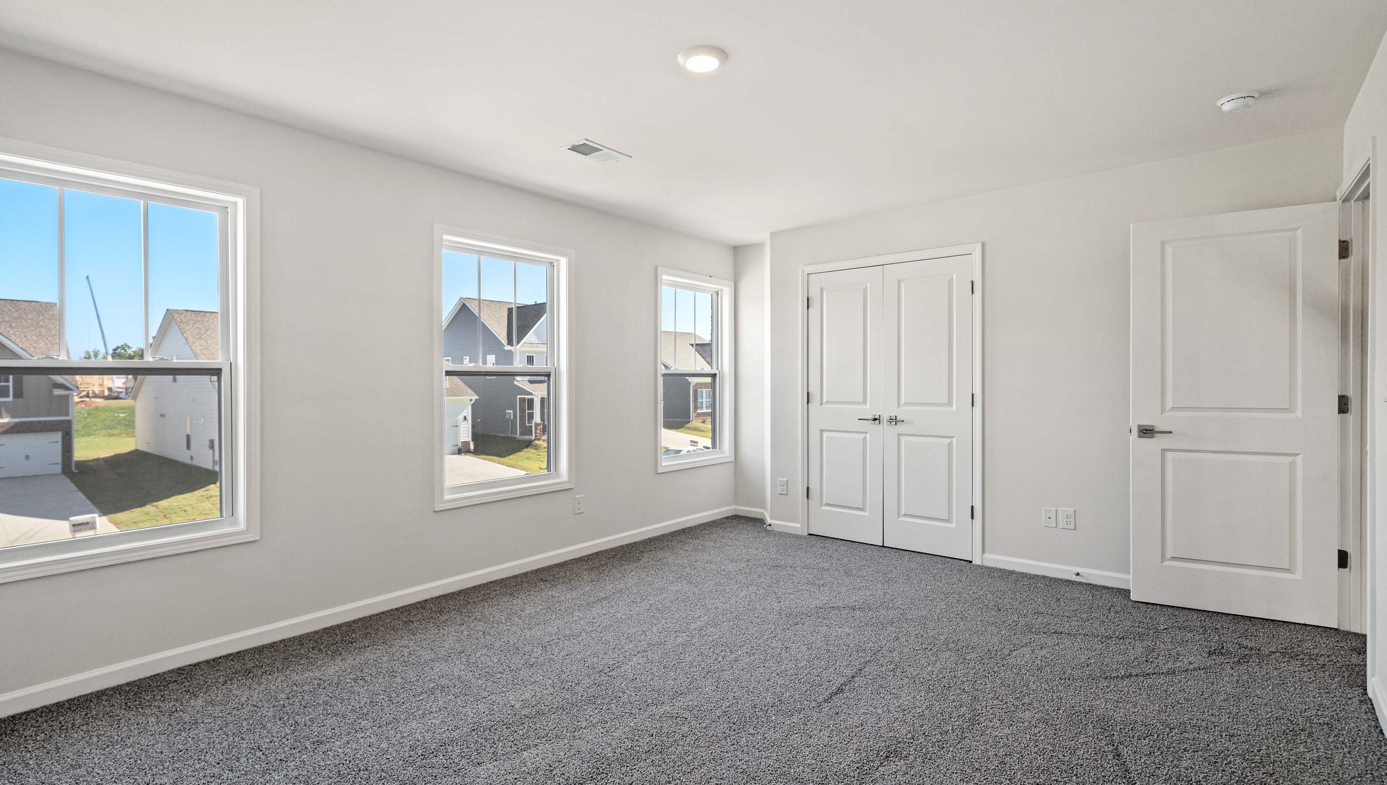 Bedroom with carpet and window.