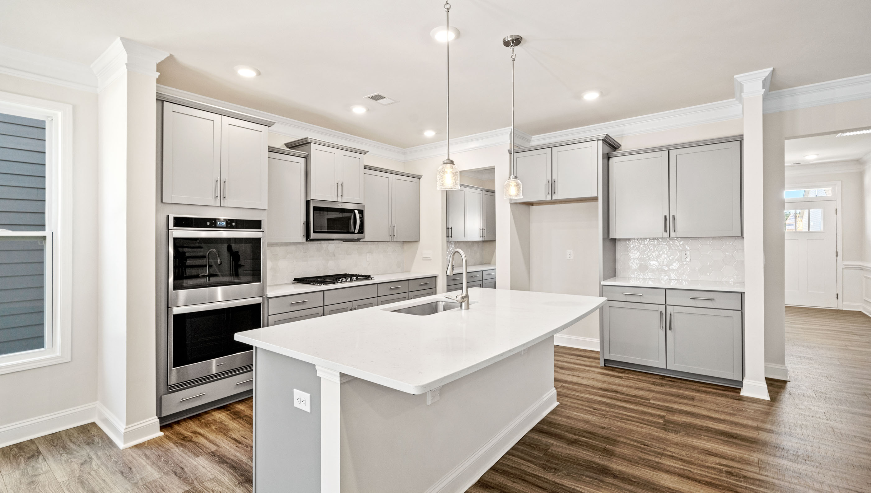 Kitchen and island with granite counter tops.