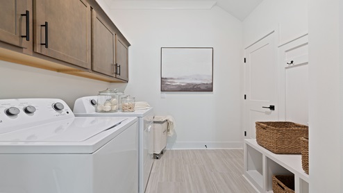 Laundry room with cabinets.