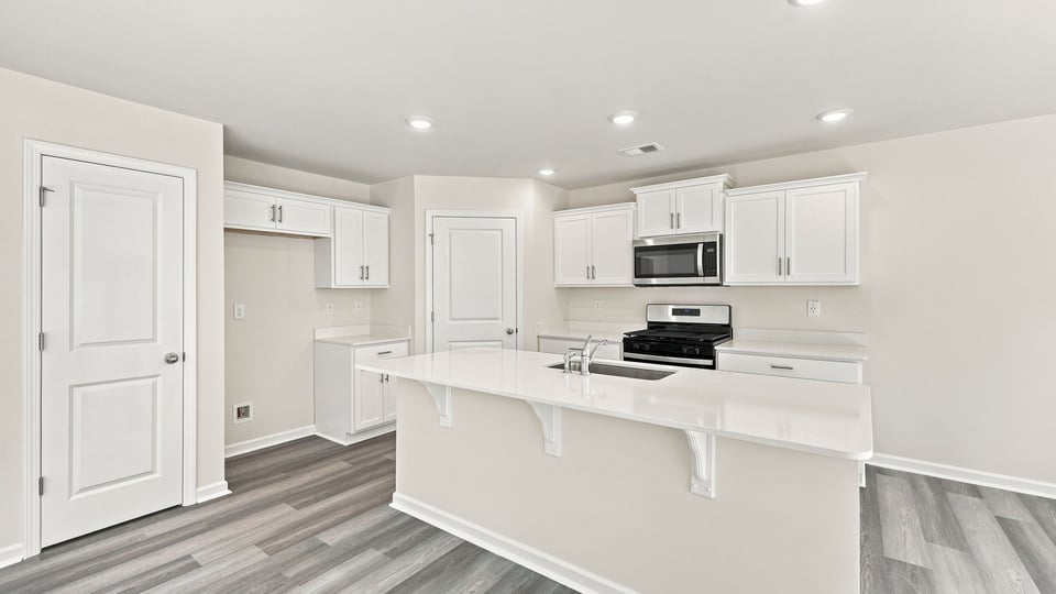 Kitchen with island and cabinets.