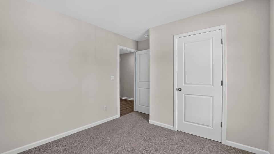 Bedroom with carpet and window.