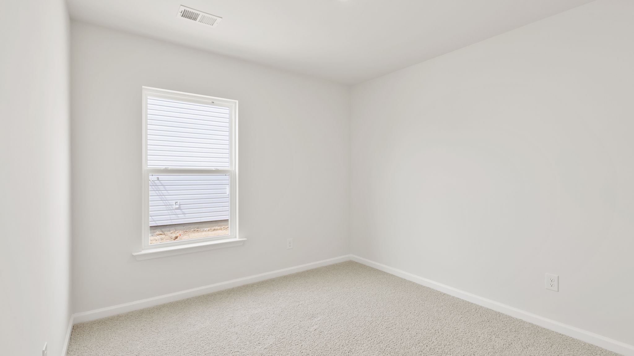 Bedroom with carpet and window.
