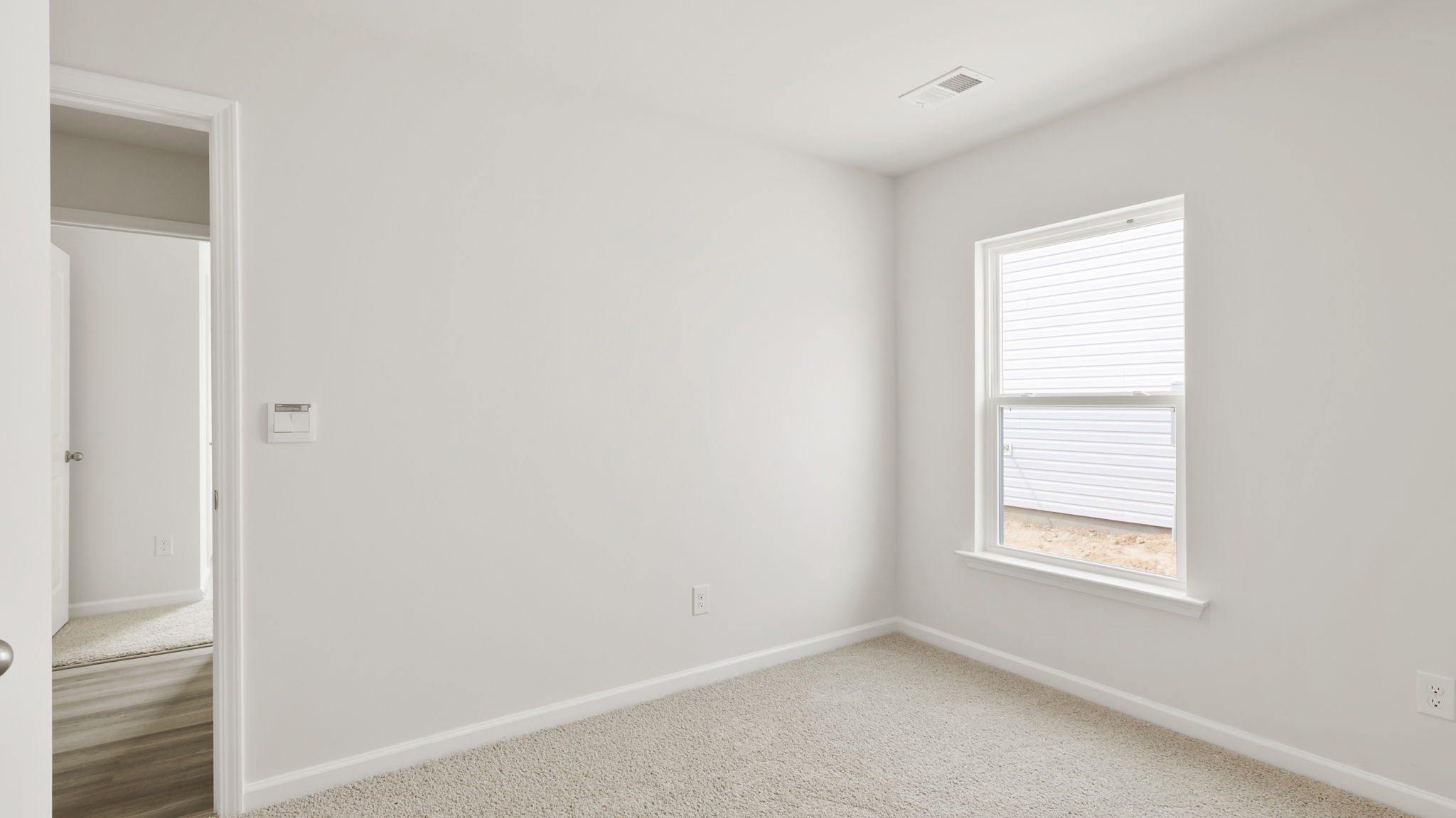 Bedroom with carpet and window.