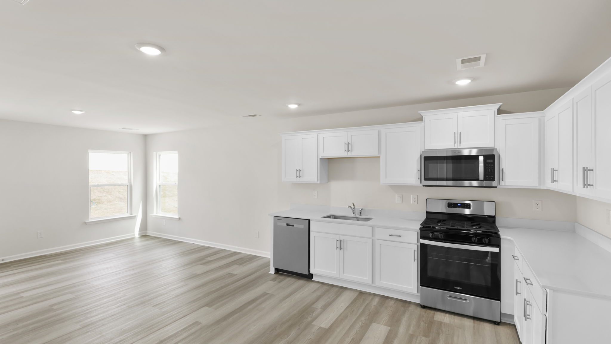 Kitchen with quartz countertops and stainless steel applainces.