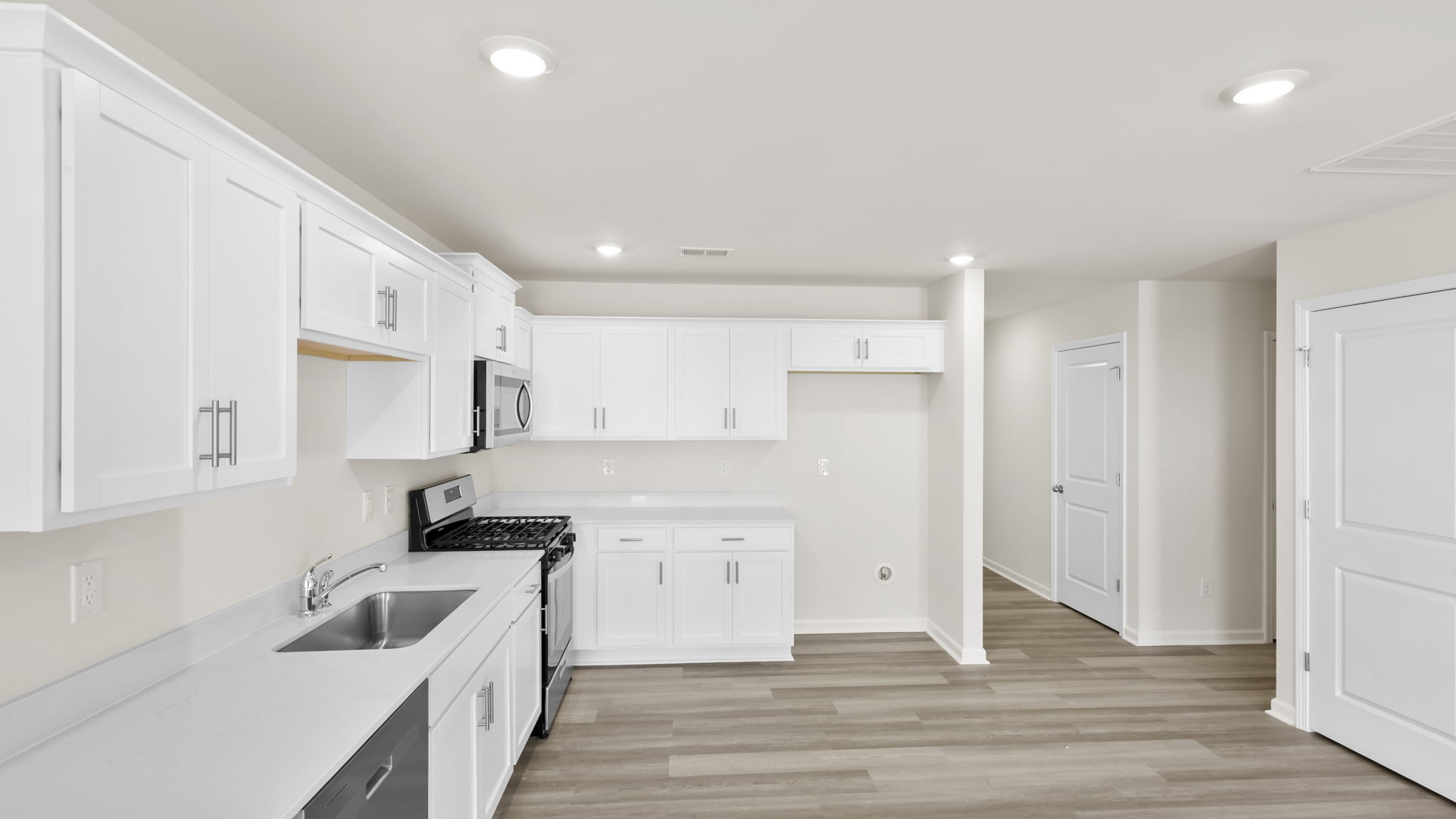 Kitchen with quartz countertops and stainless steel applainces.