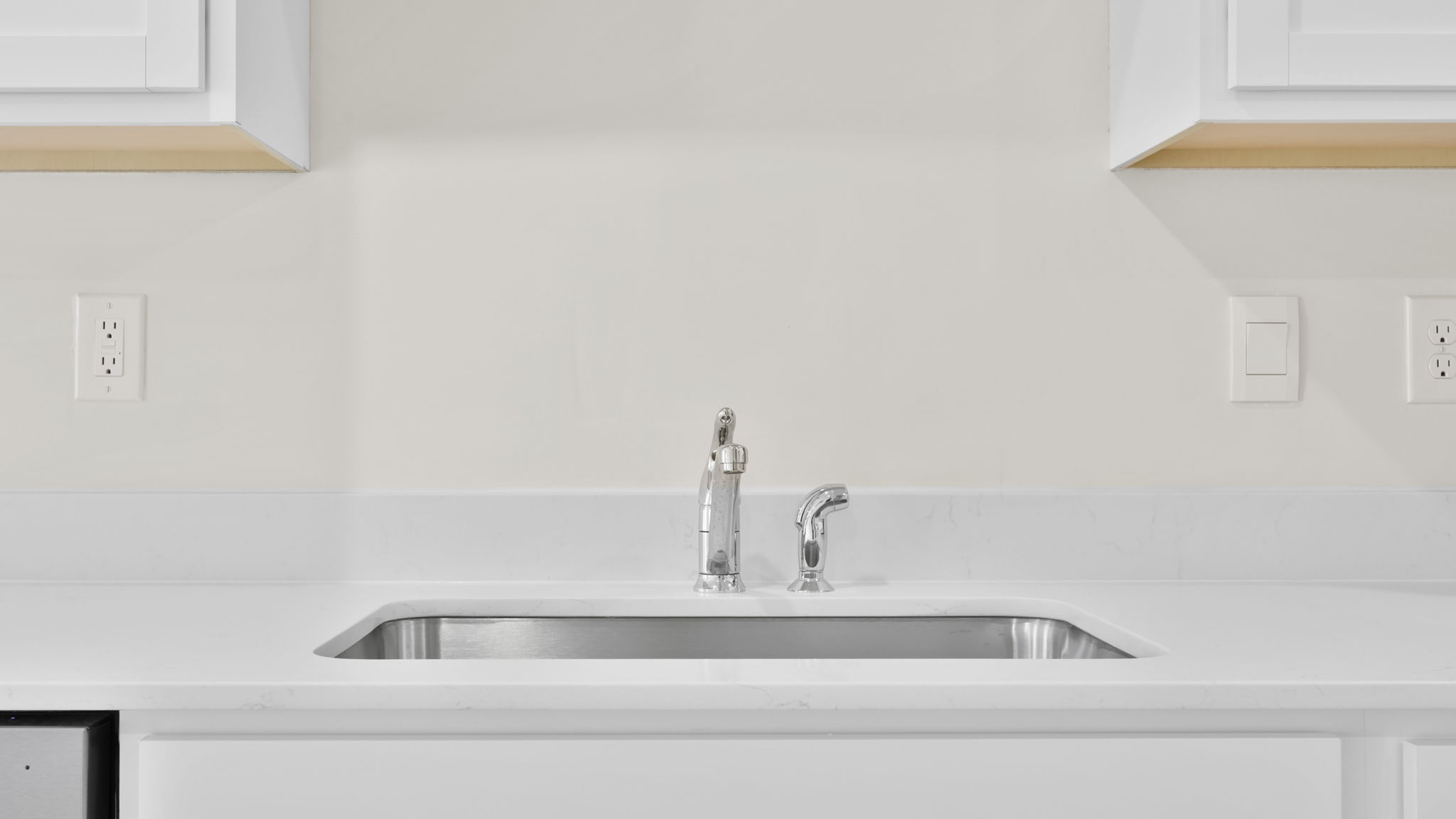 Kitchen with quartz countertops and stainless steel applainces.