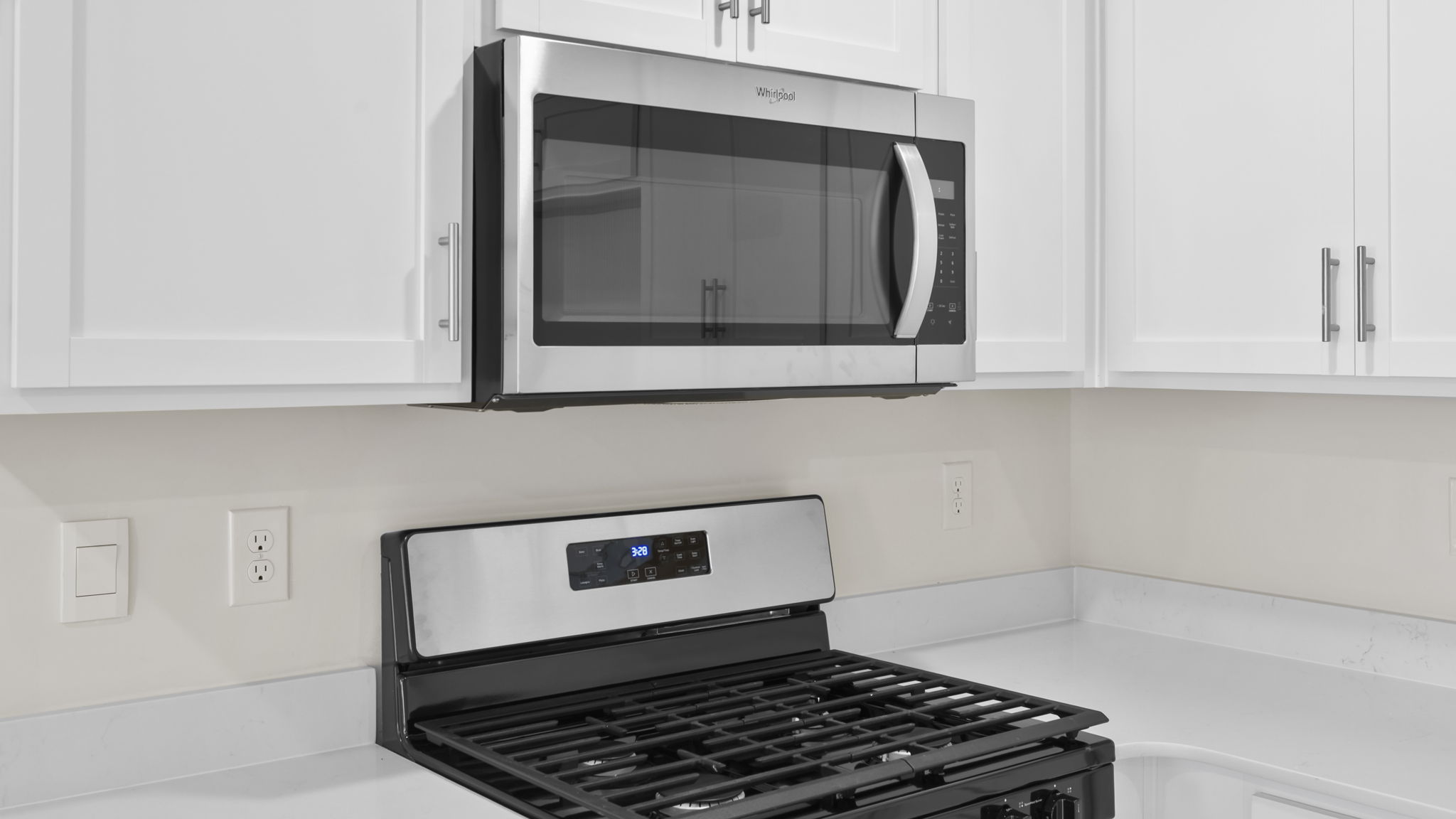 Kitchen with quartz countertops and stainless steel applainces.