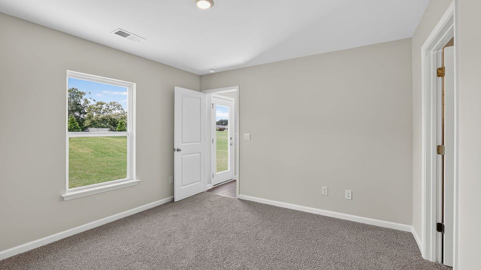 Bedroom with carpet and window.
