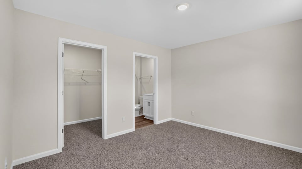 Bedroom with carpet and window.