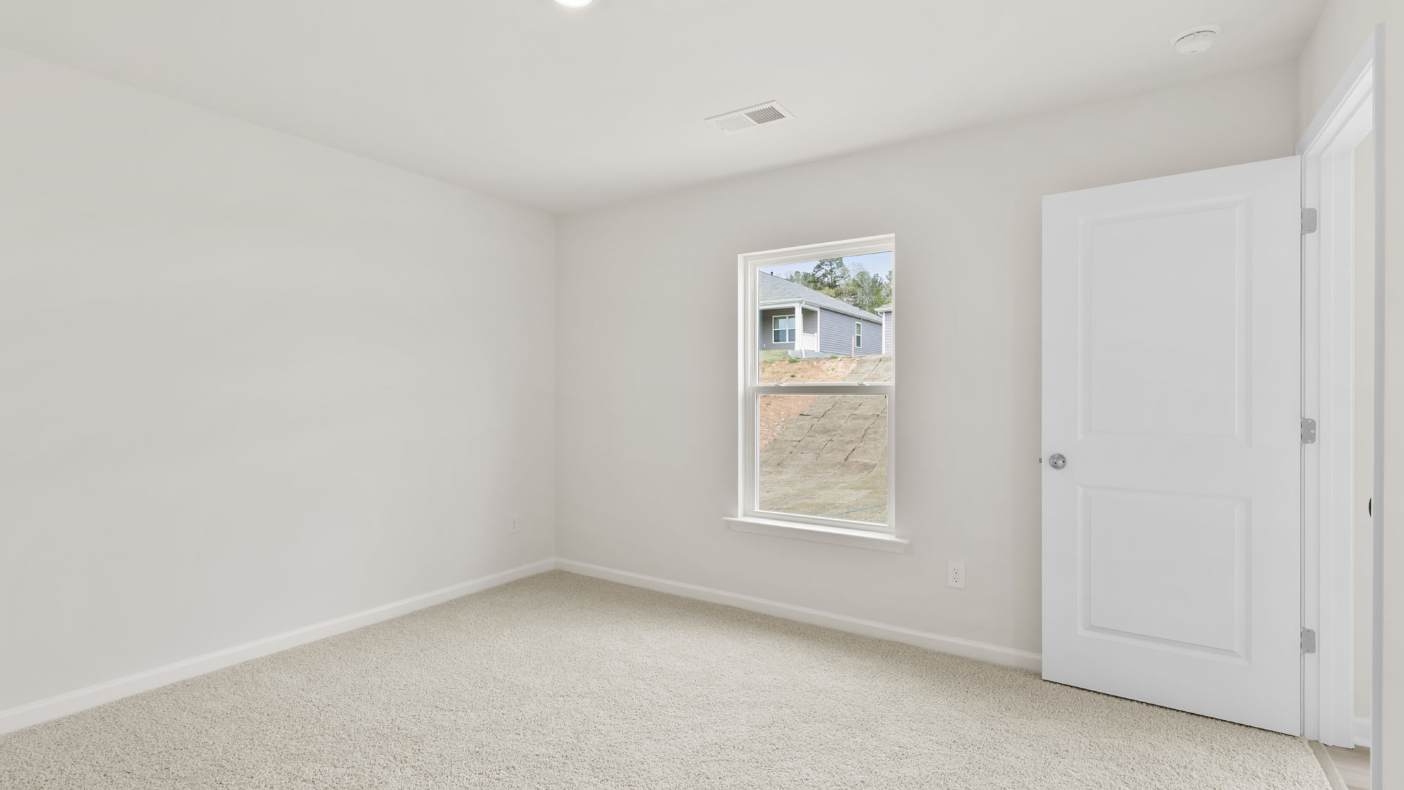 Bedroom with carpet and window.