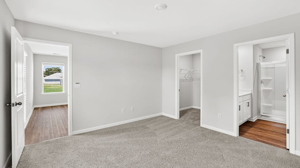 Bedroom with carpet and window.