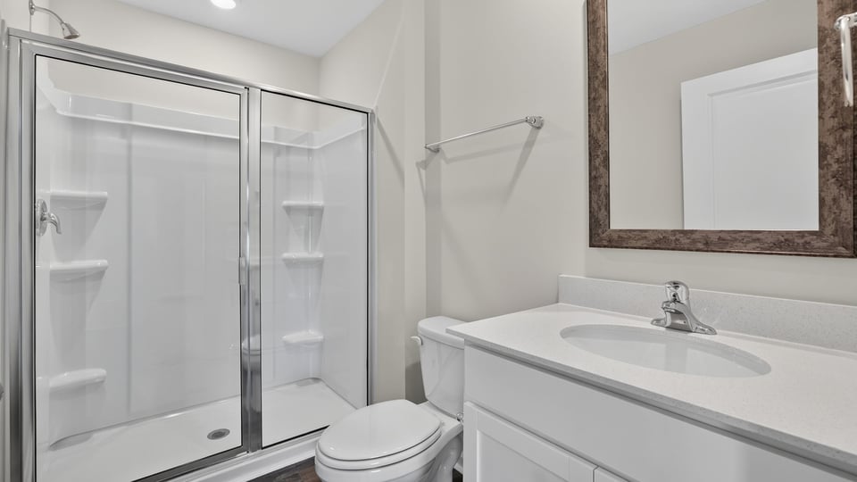 Bathroom with vanity and walk in shower.