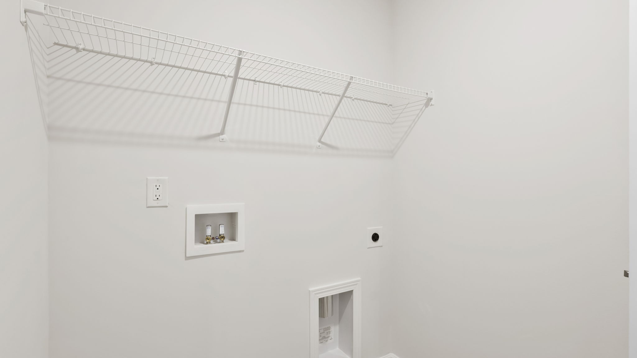 Laundry room with hanging storage racks.