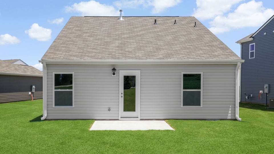 Exterior of home with large backyard.
