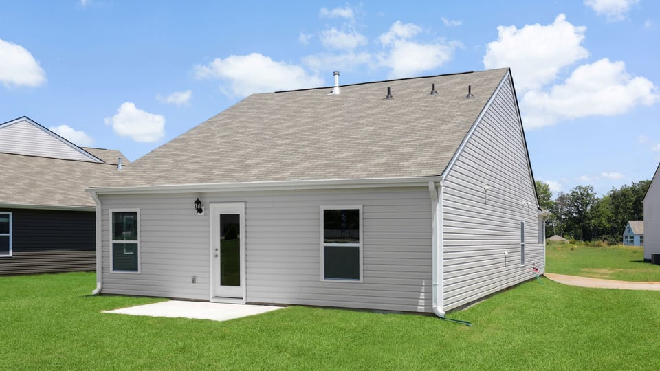 Exterior of home with large backyard.