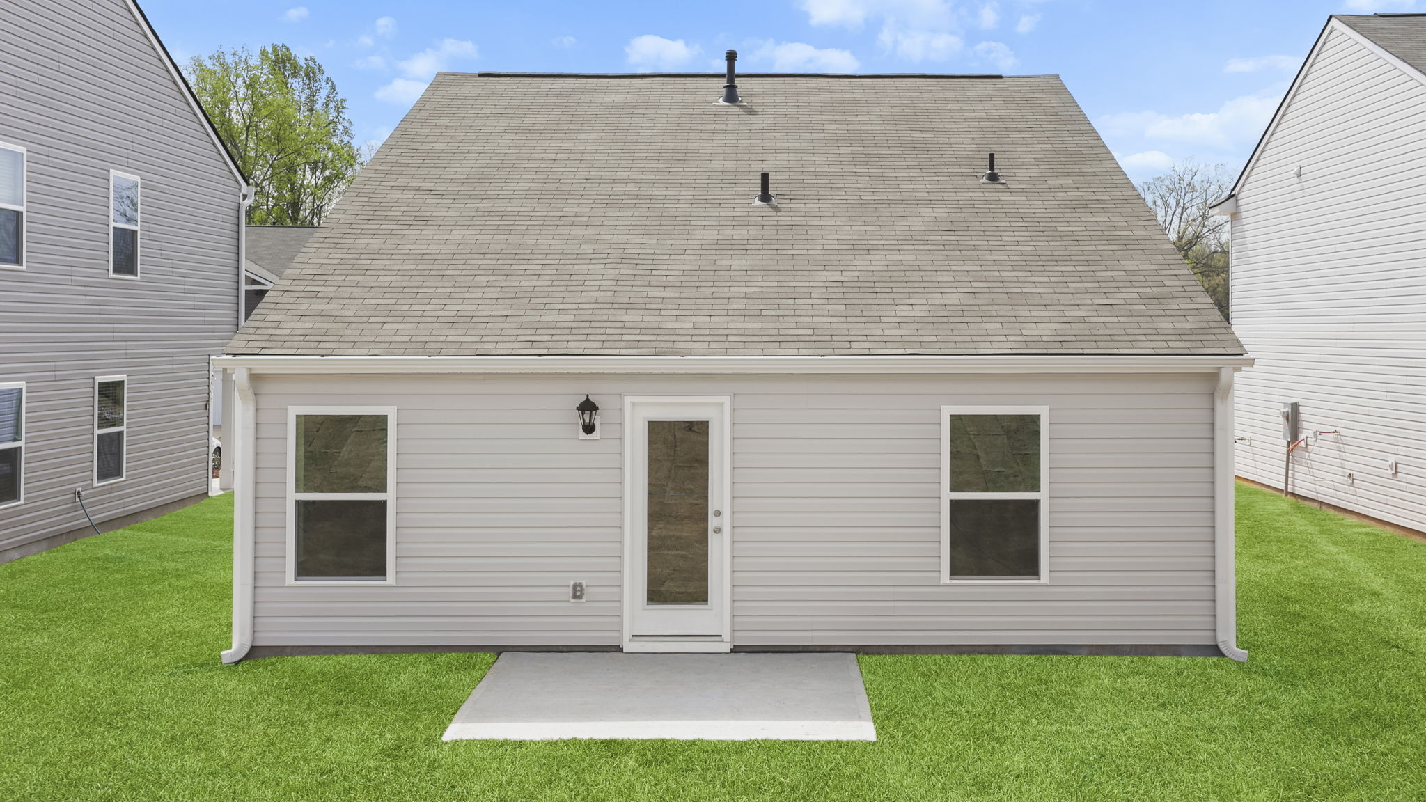 Back exterior of home with large backyard.