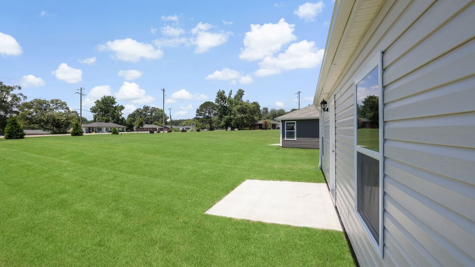 Exterior of home with large backyard.